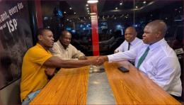 Activists Bob Njagi and Nicholas Oyoo share a moment with Kenya's High Commissioner to Uganda Joash Maangi.